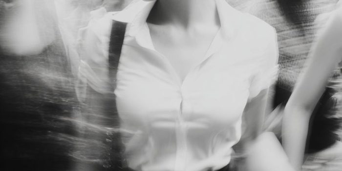 AI提示词_一位30岁的女性在混乱的城市场景中慢慢移动，穿着白衬衫和黑裙子_chat gpt会员价格缩略图